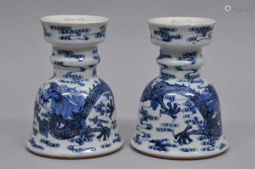 Pair of porcelain candle holders. China. 19th century. Underglaze blue decoration of dragons and celestial pearls with clouds. 5-3/4