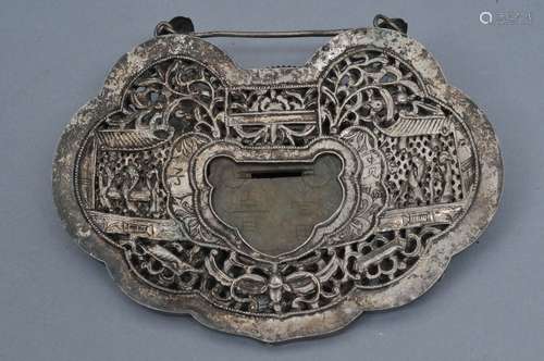 Silver ornament. China. 19th century. Lock shaped. Repousse decoration inset with a jade plaque. 5-3/4