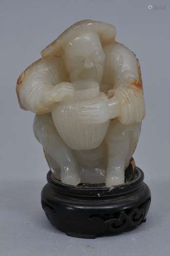 Jade carving. China. 19th century. White jade pebble carved as fisherman with a basket. The reverse with a russet skin left natural. 3