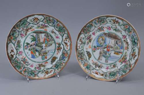 Pair of porcelain plates, China 19th century. Chinese export ware, decoration of people in palace settings with borders of birds, flowers, auspicious emblems, and pineapples. 8