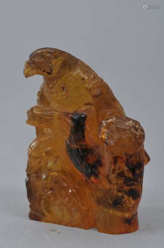 Amber carving. 20th century. Honey coloured material. Hawk perched on a branch. 2-1/2