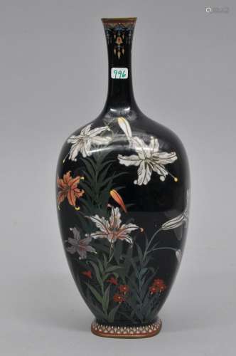 Cloisonné vase. Japan. Meiji period (1868-1912). Bottle form with flattened sides. Silver wire work of Asian lilies on a midnight blue ground. 10