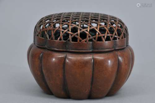 Copper hand warmer. China. Ming period. Lobated form with a basketry top. Inscription on the base. Signed Chang Ming Chi. 4