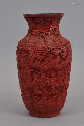 Cinnabar vase. China. Early 20th century. Surface carved with figures in a landscape. 9-1/4