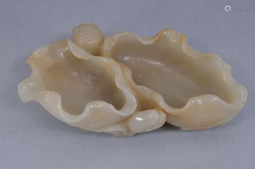 Jade water coupe. China. 19th century. Double well carved as  a lotus plant. Grey white colour with russet markings. 5-1/2