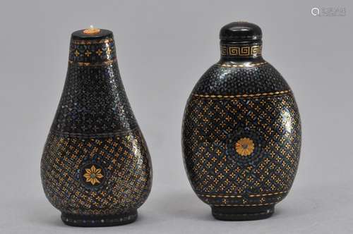 2 laq burgauté snuff bottles, China 19th century. One marked Ch'ien Yi, and the other marked with a leaf. Each about 2 1/4