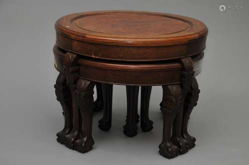 Low table with four inset stools. China. 20th century. Burlwood inlaid top. Animal form feet. Floral carving. 25