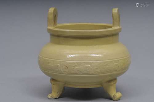 Porcelain incense burner. China. Early 20th century. Round Ting form. Single band of archaic style scrolling. Pale yellow ground. 5