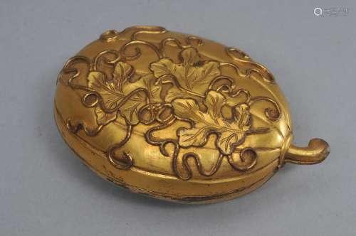 Gilt bronze box. China. 19th century. Cast as a melon with foliage and tendrils. 4-1/2
