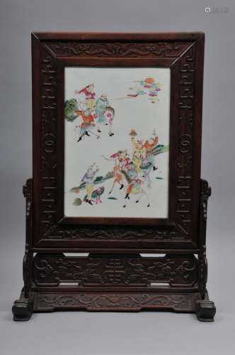 Table screen. China. 19th century. Porcelain plaque with Famille Rose decoration of The Immortals. Relief carved hardwood frame. 20-1/2