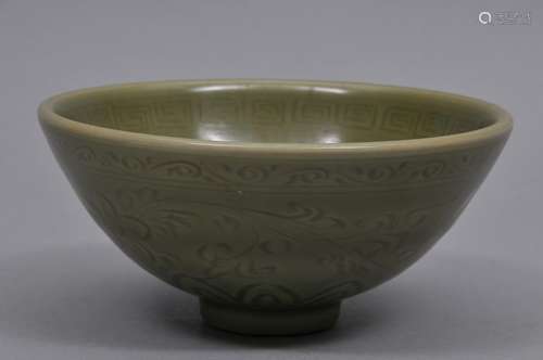 Porcelain bowl. China. 18th century. Lung Chuan ware. Dark celadon colour. Surface carved with floral scrolling. 6-1/4