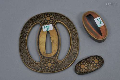 Set of sword mounts. Japan. 18th/19th century. Shibuichi inlaid with sentoku floral scrolling and heraldic mons. Set includes: Tsuba, Fuchi and Kashira.