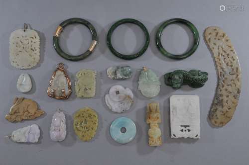 Lot of 19 assorted jades. To include: Fourteen pendants, three bracelets, a crescent and a tiger.