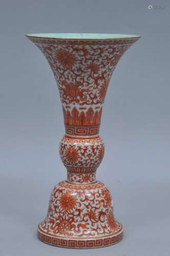 Porcelain vase. China. Ch'ia Ch'ing mark and period. (1796-1820). Ku form beaker. Iron red decoration of lotus scrolls and the eight precious Buddhist emblems. 