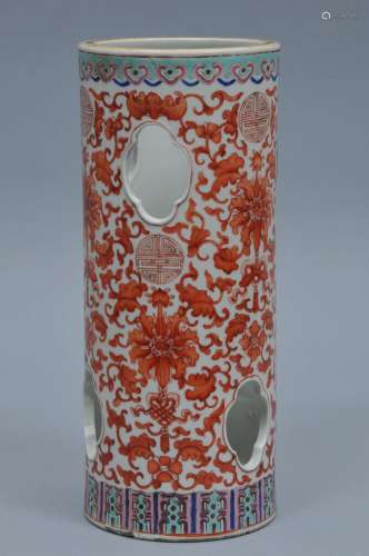 Porcelain hat stand. China. 19th century. Cylindrical form with quatrefoil piercings. Iron red decoration of floral scrolling and shou characters. Famille Rose borders. 11-1/2