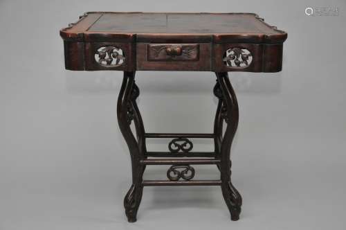 Hardwood gaming table. China. 19th century. Surface carved with panels of peaches. Four drawers. 32