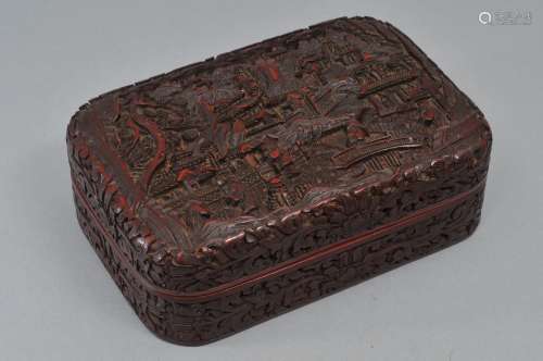 Cinnabar lacquer box. China. 19th century. Rectangular form with rounded corners. Surface carved with figures in a palace garden with floral borders. 6