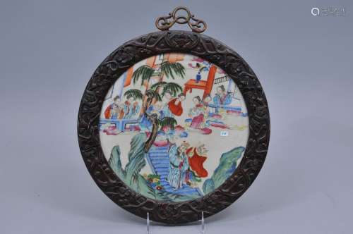 Porcelain plaque. China. 19th century. Circular shape. Famille Rose decoration of the Immortals. Finely carved hardwood frame. Brass hanger. 13