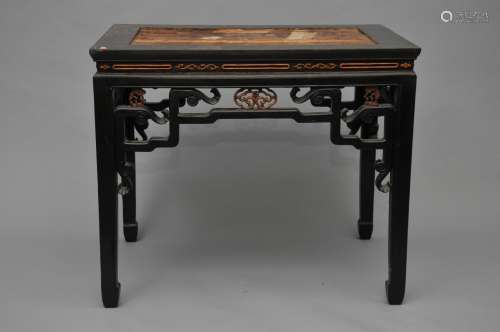 Occasional table. China. Late 19th century. Black wood with inlaid lighter panels. Carved with ling chih. 37