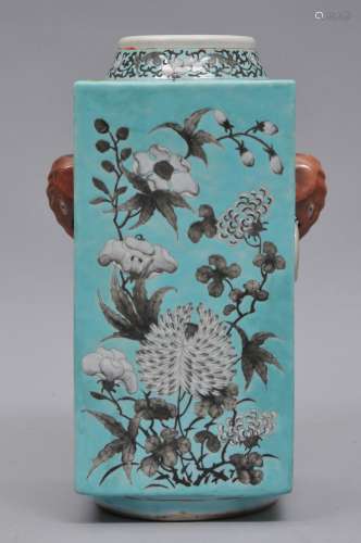 Porcelain vase. China. 19th century. Tsung shaped with elephant mask handles. Grisaille decoration of flowers on a turquoise ground. 11-1/2