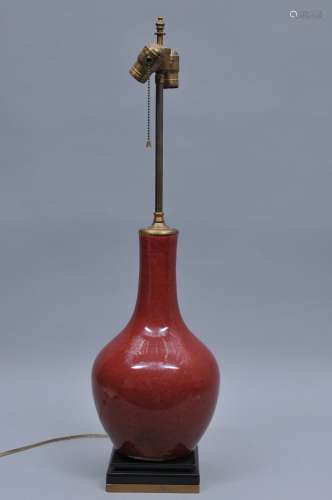 Porcelain vase. China. 19th century. Bottle form. Oxblood glaze. Drilled and mounted as a lamp. 15