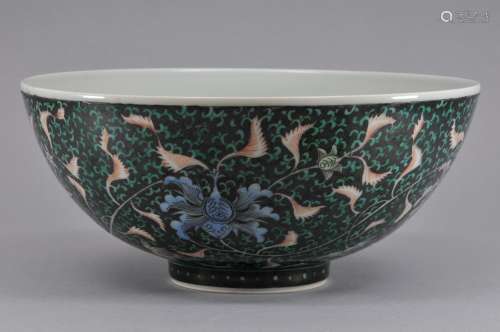 Porcelain bowl. China. 20th century. Famille Verte decoration of lotus scrolls on a black ground. Ch'ia Ch'ing mark. 8-1/2