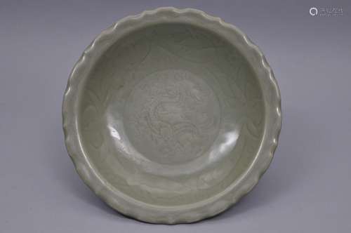 Porcelain plate. China. Ming period. (1368-1644)/ Lung Chuan ware. Celadon glaze. Surface carved with a dragon and lotus flowers. 11-3/4