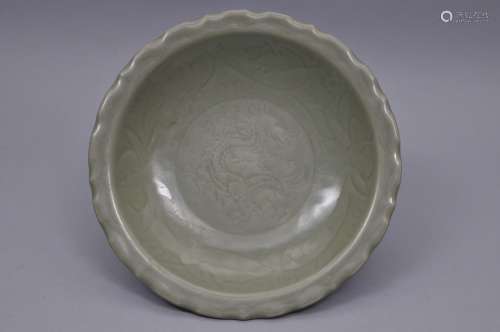 Porcelain plate. China. Ming period. (1368-1644)/ Lung Chuan ware. Celadon glaze. Surface carved with a dragon and lotus flowers. 11-3/4