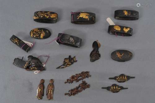 Lot of assorted sword mountings. Japan. 18th/19th century. Three pairs of menuki, three single menuki (one mounted as a pin), one fuchi-kashira set, one kashira and five fuchi (mixed metal work).