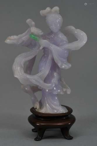 Jadeite carving of a Kuan Yin. China. 20th century. Deep purple lavender stone with one bright apple green marking. 4