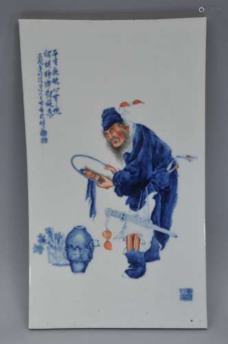 Porcelain plaque. China. Republican period. Underglaze blue and iron red. Decoration of Shuke looking in a mirror. 21