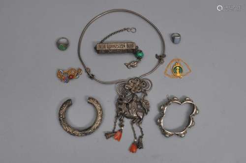 Lot of 8 Pieces of Chinese silver jewelry. 19th/20th century. To include: A necklace, two bracelets, a chatelaine, a pin, two rings and a jade disk with gold mounts.