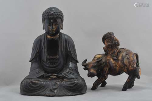 Lot of two carved wooden figures. To include: A seated