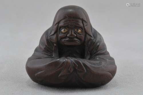 Carved wooden Netsuke. Japan. 19th century. Seated