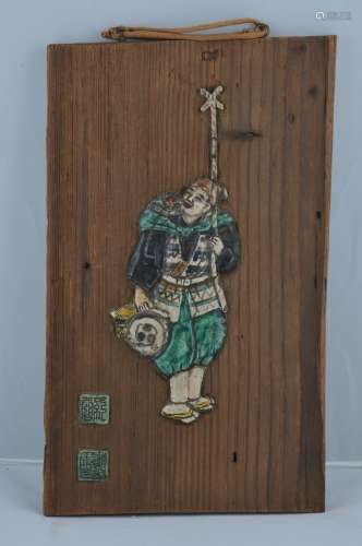 Wooden plaque. Japan. 19th century. Pottery inlay of a