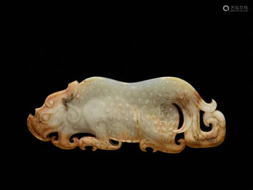 AN EXQUISITE PLAQUE IN WHITE TRANSLUCENT JADE FINELY CARVED IN THE SHAPE OF A CROUCHING TIGER