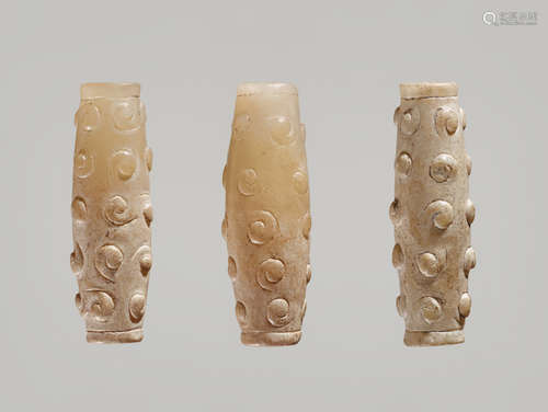 THREE TINY BI-CONICAL BEADS IN WHITE JADE WITH DELICATELY CARVED SCROLLS IN RELIEF