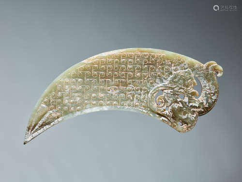 A VERY RARE GREEN CRESCENT SHAPED XI 觿 OR “KNOT-OPENER” WITH A COILED DRAGON AND A PATTERN OF ENGRAVED LINKED SCROLLS