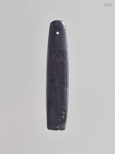 A BLACK STONE AXE BLADE