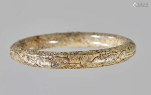 AN INSCRIBED GREY-BROWN MOTTLED NEPHRITE ‘CHILONG AND TAPIR’ BANGLE