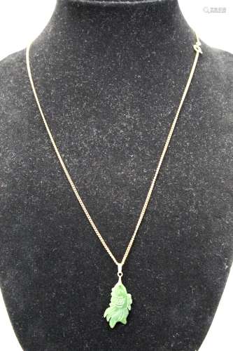 Necklace with green jade fish pendant.