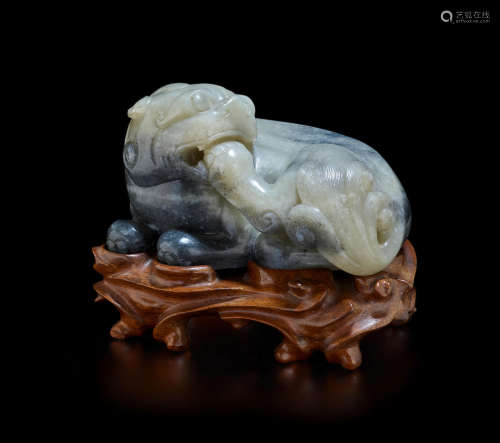 Qing dynasty A CELADON AND BLACK JADE FIGURE OF A MYTHICAL BEAST