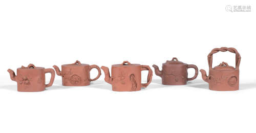 19th/20th century A group of Yixing teapots and covers with moulded and applied decoration
