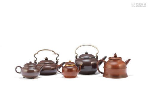 Early Qing Dynasty and later A selection of metal-mounted Yixing stoneware teapots and covers