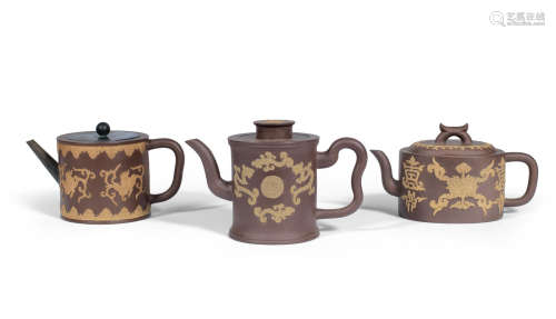 Mid Qing Dynasty  Three Yixing teapots with applied decoration