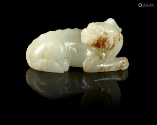 17th/18th century A green and russet jade figure of a recumbent mythical beast