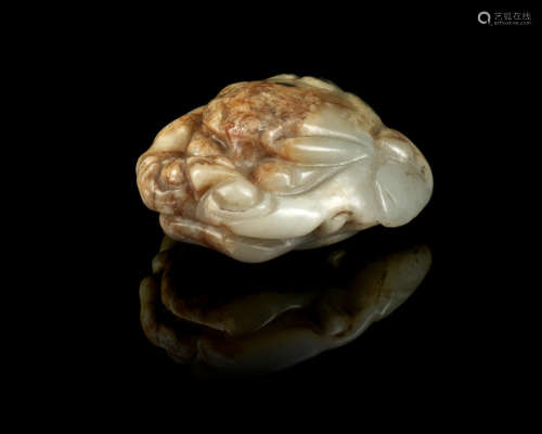 Han Dynasty A rare white and russet jade 'lion head' fitting