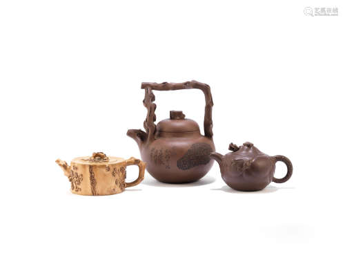 Early 20th century  Three Yixing teapots and covers