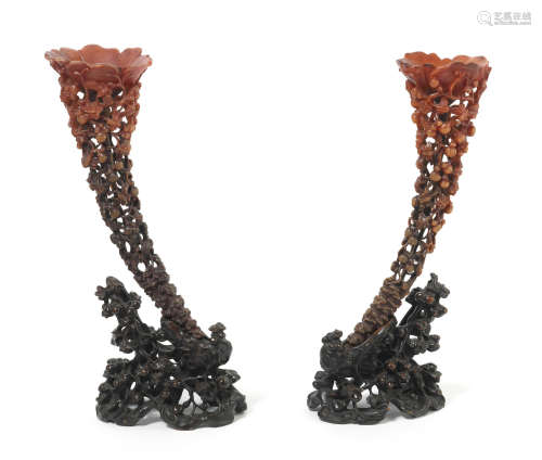 Late Qing Dynasty A pair of large rhinoceros horn openwork libation cups and hardwood stands
