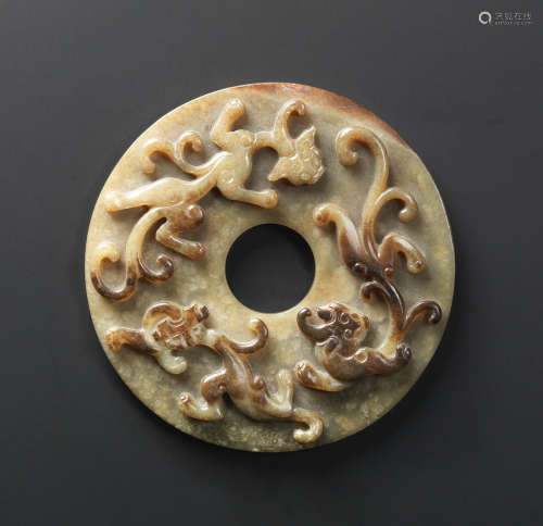 Ming Dynasty A fine pale green and russet jade 'chilong' disc, bi